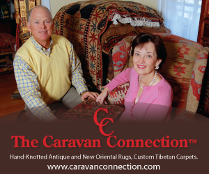 Owners of an oriental rug store in Westchester, NY in their area rug showroom